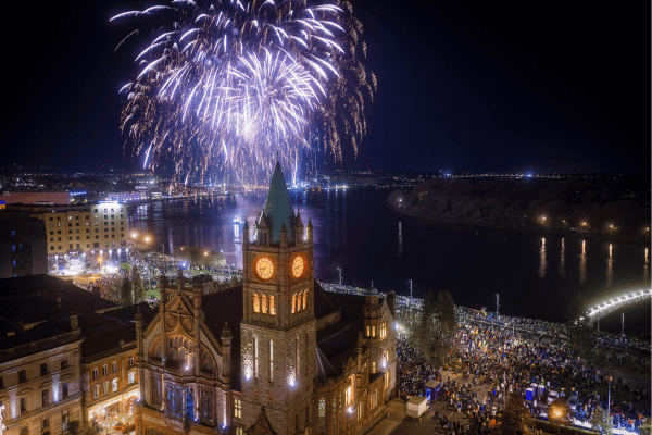 Fireworks above Derry Halloween parade at night