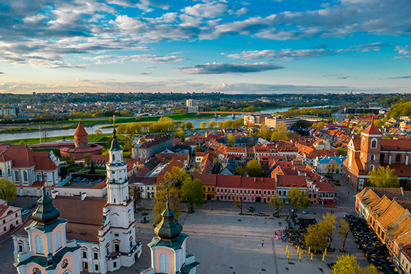 Aerial view of square with church in Kaunas, with river in the background