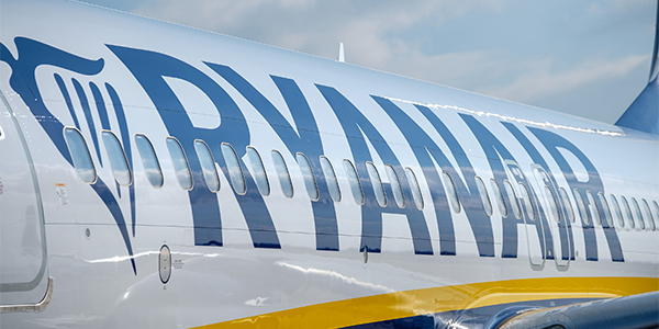 Main square in Marrakesh at night with market stalls in the foreground and the tower of Koutoubia Mosque in the background