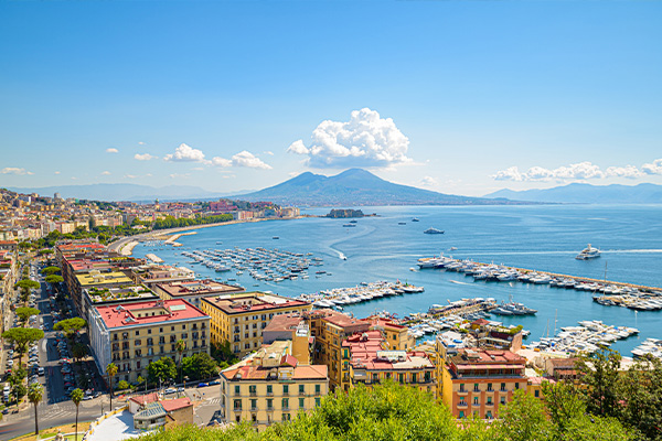 Elevated view of a harbour in Naples with Mount Vesuvius in the background