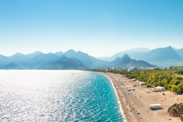 A beach with mountains in the background