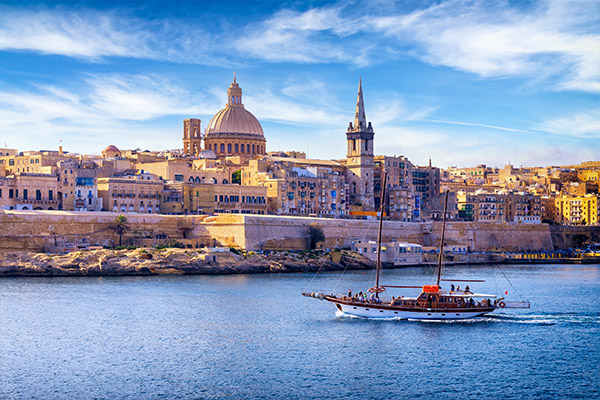 Boat sailing past the skyline of Valletta