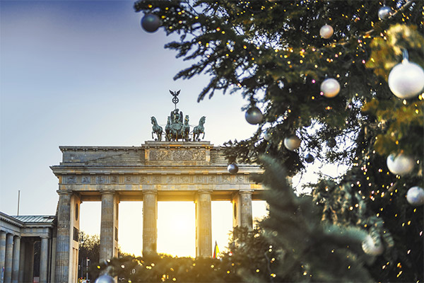 A partial view of the Brandenburg Gate from behind a Christmas tree