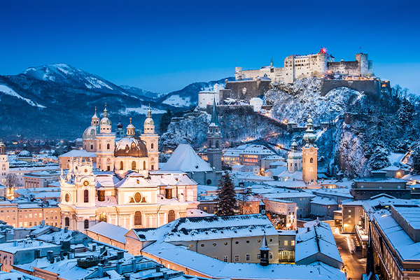 An eveningtime panorama of a snow-covered Salzburg.