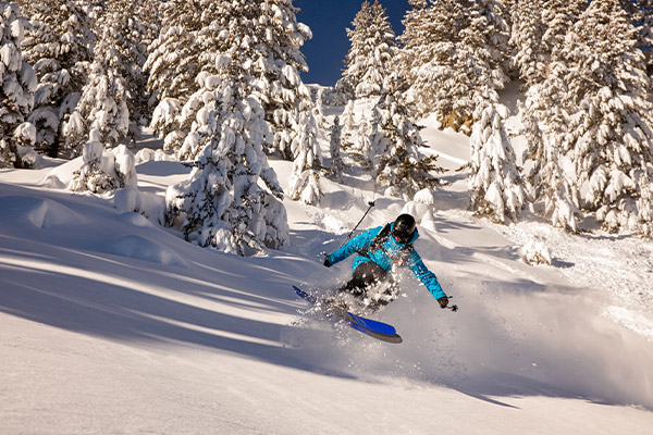 A skiier going down a slope in Bansko, Bulgaria.
