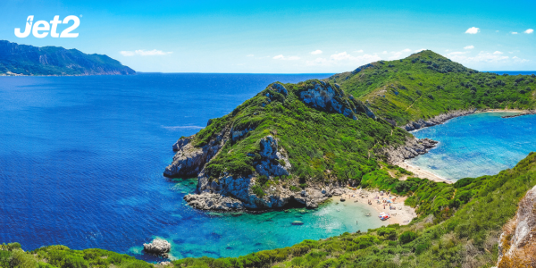 A sweeping shot of a green-covered rocky coastline