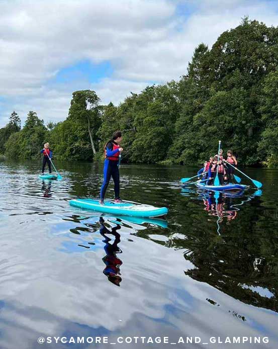 Kids paddleboarding in Northumberland