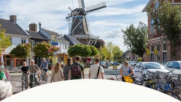 Drukke winkelstraat met wandelaars en lokale winkels