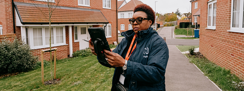 Hyde Neighbourhood Officer working on their tablet