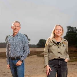 Dame met haar hond voor haar huis.