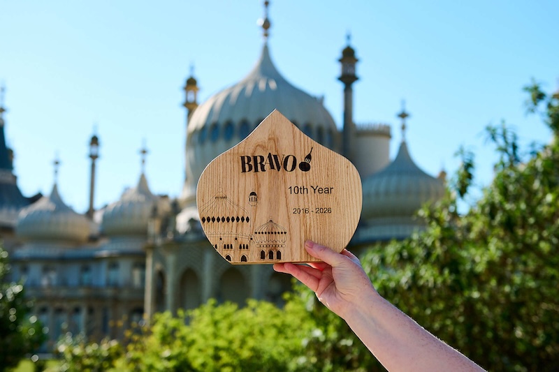 Bravo 2026 Trophy being held in front of pavillion