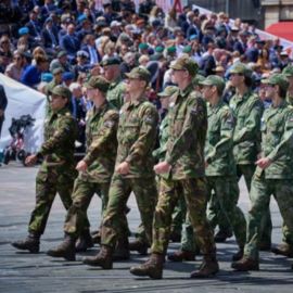 Foto van militairen in GVT die langs de tribuneplaatsen marcheren op de Nederlandse Veteranendag.