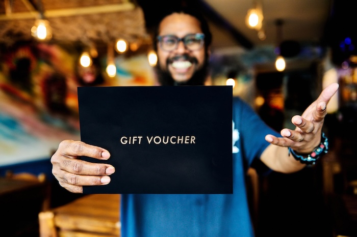 Naveen holding gift voucher